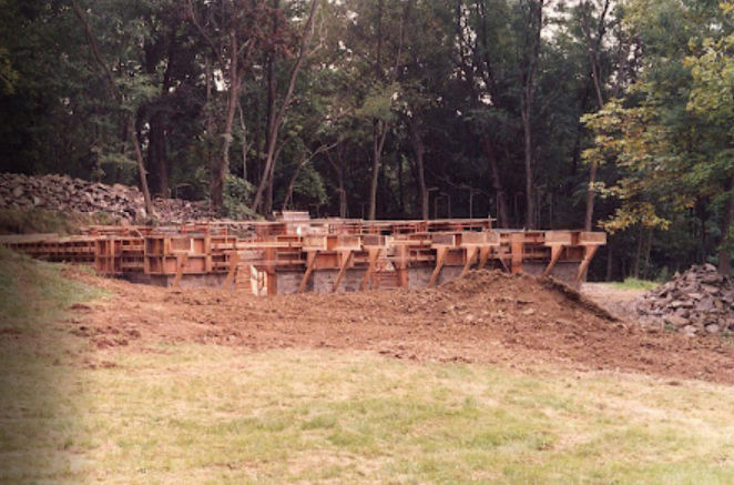 Slip-form fieldstone wall rising in courses